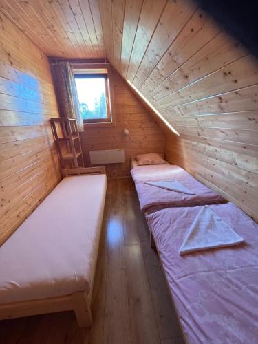 a small room with two beds in a cabin at Chata Drevenica Orava in Oravská Lesná