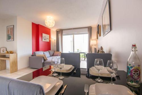 uma sala de estar com uma mesa com copos de vinho em L'escale em Angers