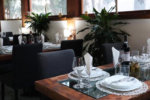 a table with plates and wine glasses on it at Villa Alba Boutique Hotel in Pescara