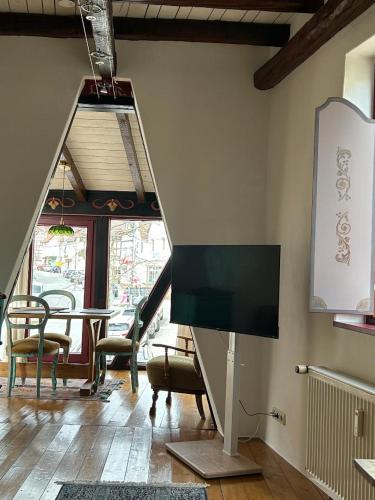 a living room with a flat screen tv on the wall at Gemütliches Scheunenfachwerkhaus nahe Frankfurt mit Glasfaser und Klima in Bad Soden am Taunus