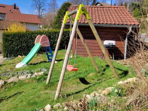 a group of playground equipment in a yard at appartement Gérardmer proche lac et centre ville in Gérardmer