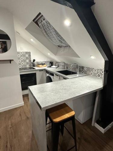 a kitchen with a sink and a counter top at Appartement 2 in Dunkerque