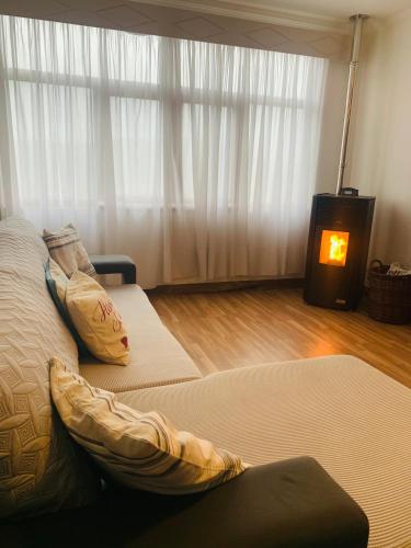 a bedroom with two beds and a fireplace in it at Anjú-Pardal in Mogadouro