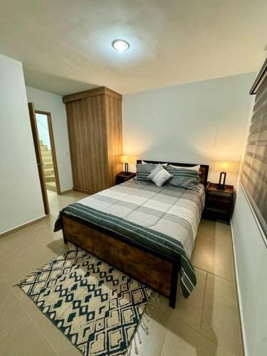 a bedroom with a bed and a rug at Casa Costa Azul in Las Dos Palmas