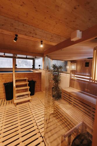 a sauna with a glass wall in a building at Royal Alpin Crown in Cavnic