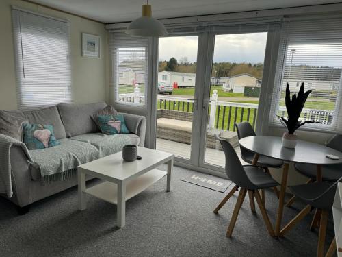 a living room with a couch and a table at Cleethorpes beach haven site in Cleethorpes