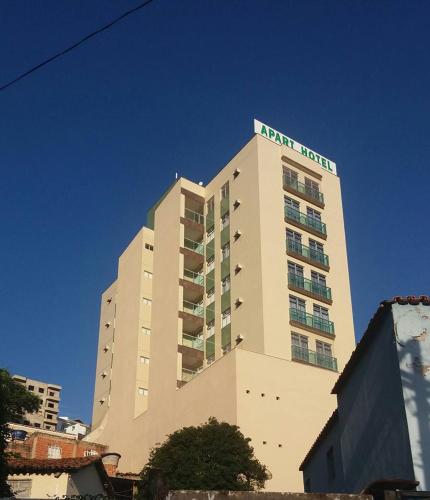 a tall building with a hotel on top of it at Manhattan Apart Hotel in Caratinga