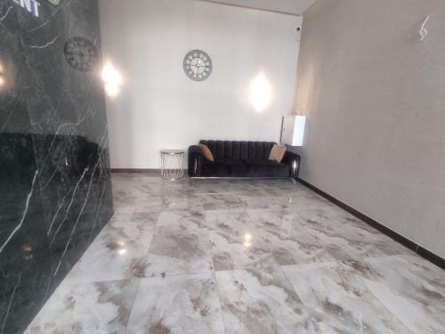 a living room with a couch and a marble floor at Spacious Apartment in Yerevan, CENTRE in Yerevan