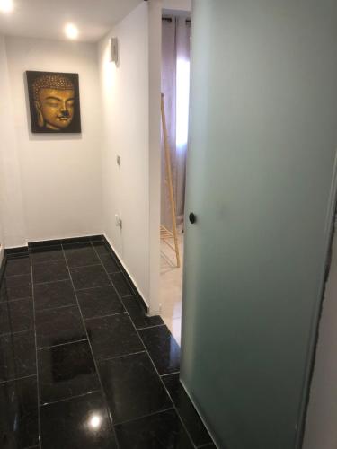 a hallway with a tile floor and a painting on the wall at Luxury Apartments Christos in Gouvia