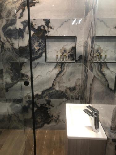 a bathroom with a sink and a shower at Luxury Apartments Christos in Gouvia