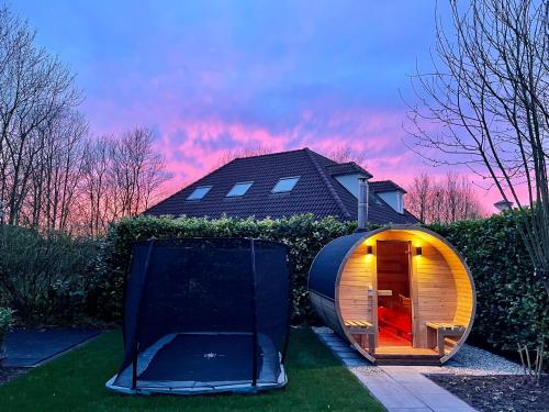 a round house with a door in the yard at Newly renovated luxurious Villa / hottub / sauna / 7 bedrooms in Zeewolde