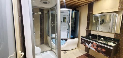 a bathroom with a shower and a sink at Seasons Apartments in Jazan