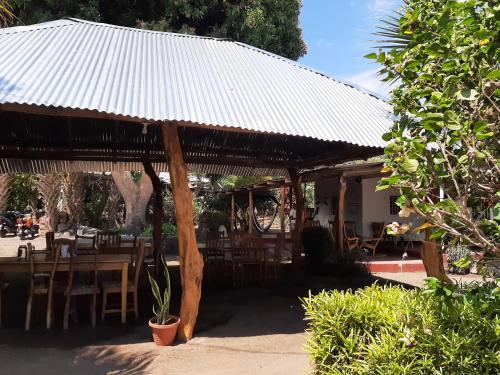 a wooden pavilion with a table and chairs and a table at Playa Casa Nohelia in Santo Domingo