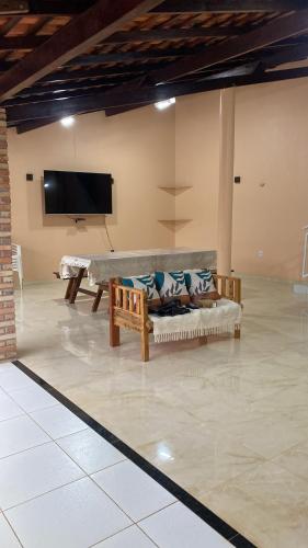 a living room with a couch and a flat screen tv at Pousada Lençóis Encantados - Centro de Barreirinhas in Barreirinhas