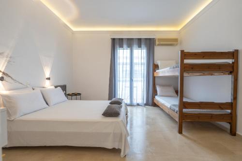 a bedroom with a bed and a bunk bed at Bellisimo studios in Zakynthos Town