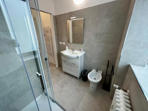 a bathroom with a sink and a toilet at Luxury Urban Oasis Apartment in center Of Udine in Udine