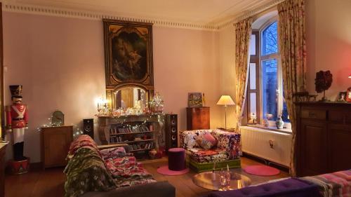 a living room with a couch and a table at Le Chant du coucou in Huy