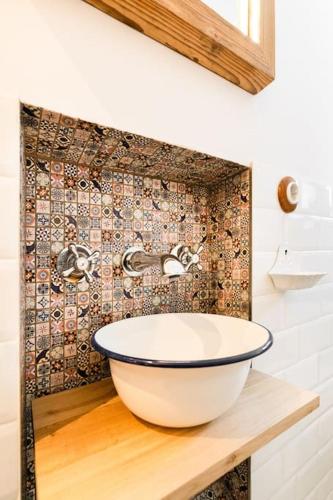 a bathroom with a bowl sink on a counter at Haus Tupferl in Niedernsill