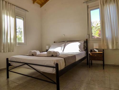 a bedroom with a bed with two towels on it at Garden Ηouse 3 in Plomari