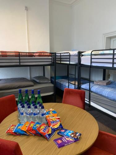 a table with bottles of water and snacks and bunk beds at Eden Quay Guesthouse Private Rooms in Dublin