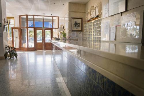 a kitchen with a long counter in a building at Hotel Neptuno in Oropesa del Mar