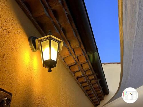 a light on the side of a building with a window at Casa di campagna nel Parco del Pollino in Teana