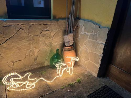 a light projected onto a wall with a bike and a bottle at Casa di campagna nel Parco del Pollino in Teana