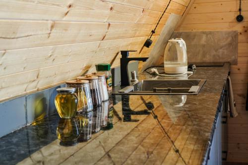 a kitchen with a counter with a sink and jars at Cottage in Gudauri Hillsideinn in Kʼumlistsʼikhe