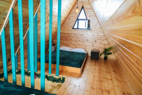 a room with a bed in a wooden house at Cottage in Gudauri Hillsideinn in Kʼumlistsʼikhe