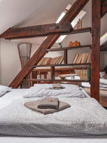 a bedroom with a large bed with white sheets at Blue Lotus Apartments in Bratislava