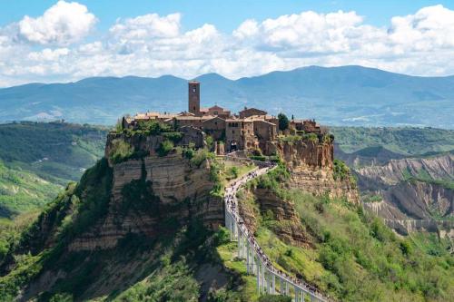 a castle on the top of a mountain at Your luxury room Civitella in Civitella dʼAgliano