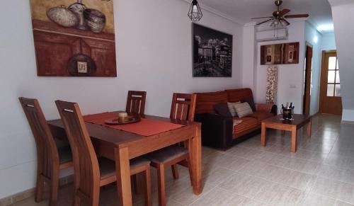 a living room with a table and a couch at CASA GARIJO - San Juan de los Terreros in San Juan de los Terreros