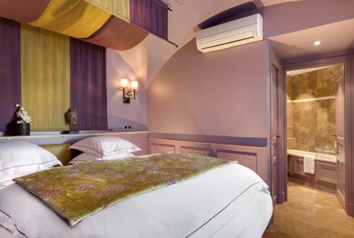 a bedroom with two beds and a window at Hôtel du Château & Spa - Teritoria in Carcassonne