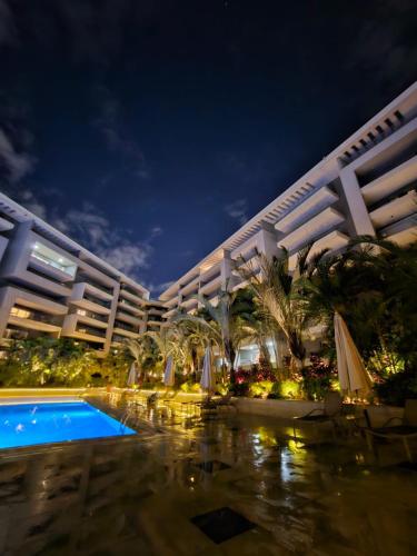 a large hotel with a swimming pool at night at Sheraton Ocean 503 - Private Apartments in Cairo