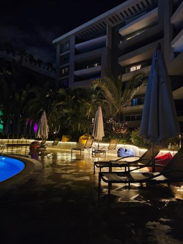 a pool with chairs and umbrellas next to a building at Sheraton Ocean 503 - Without Pool access in Cairo