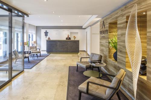 a lobby with chairs and a reception desk at The Alex Hotel in Freiburg im Breisgau