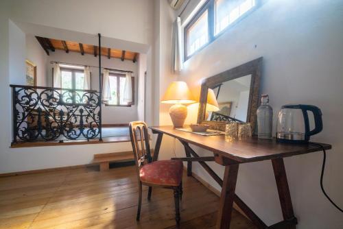 a room with a desk with a mirror and a chair at Casa Camboni-Dimora Storica Bed & Breakfast in San Vito