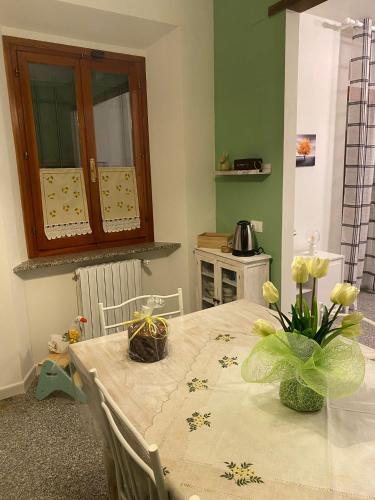 a kitchen with a table with flowers on it at Casa Vacanze Podere San Giusto Volterra in Volterra