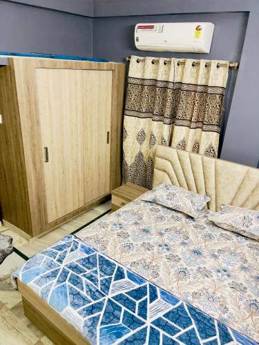 a bedroom with a bed and a air conditioner at Prince Castle-2BHk Luxurious Apartment/Guesthouse in Hyderabad