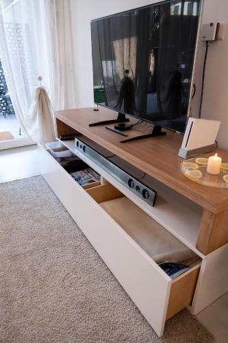 a living room with a tv on top of a table at GINNY HOUSE VENEZIA in Dolo