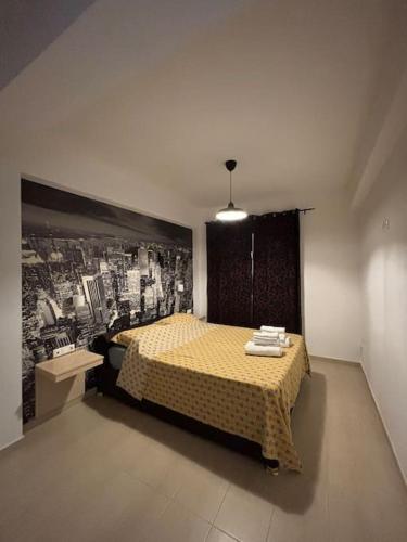 a bedroom with a yellow bed with a picture on the wall at DT Garden's Apartment in Drama