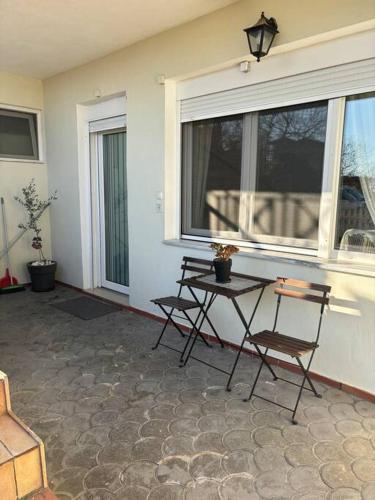 a porch with two chairs and a window at DT Garden's Apartment in Drama