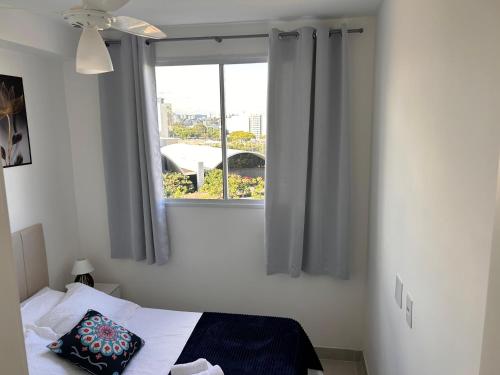 a bedroom with a window and a bed with a pillow at M.APTO barra funda in São Paulo