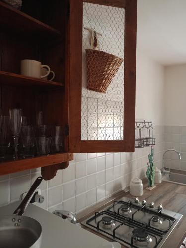 a kitchen with a stove top oven in a kitchen at Gipsy Maisonette in Lucca