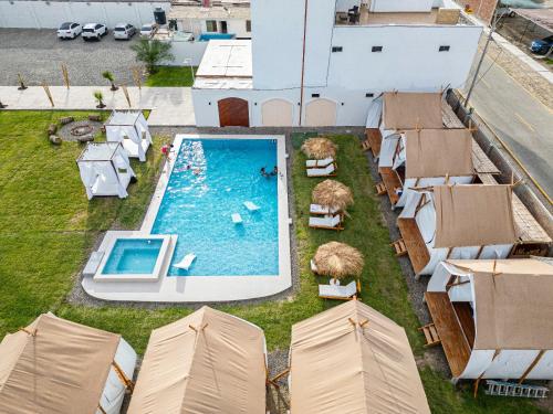 an overhead view of a swimming pool with tents at Mystic Paracas Hotel in Paracas