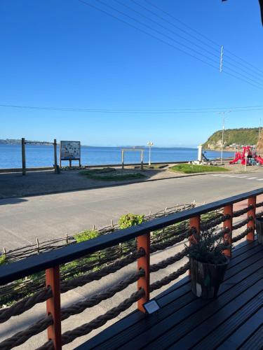 a deck with a view of the beach at ARCA HOTEL BOUTIQUE in Achao