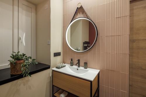 a bathroom with a sink and a mirror on the wall at Mountain Love in Saint-Claude