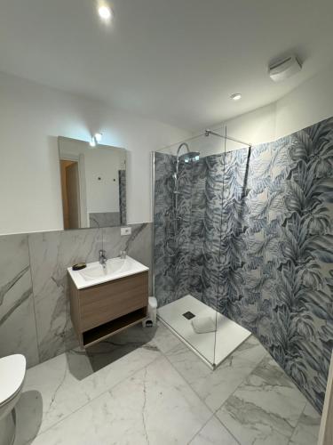 a bathroom with a sink and a mirror and a shower at San Giuliano Palace in Catania