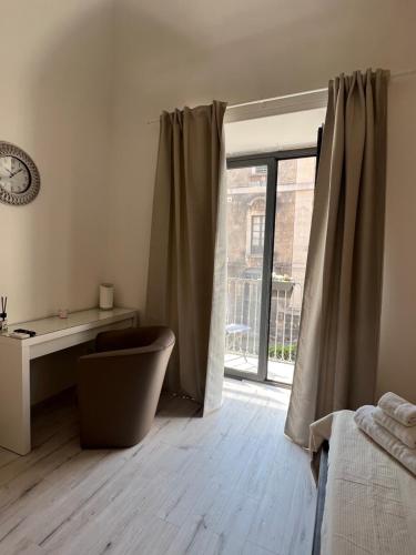 a bedroom with a bed and a sliding glass door at San Giuliano Palace in Catania