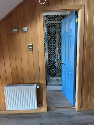 a blue door leading into a room with a radiator at ARCA HOTEL BOUTIQUE in Achao